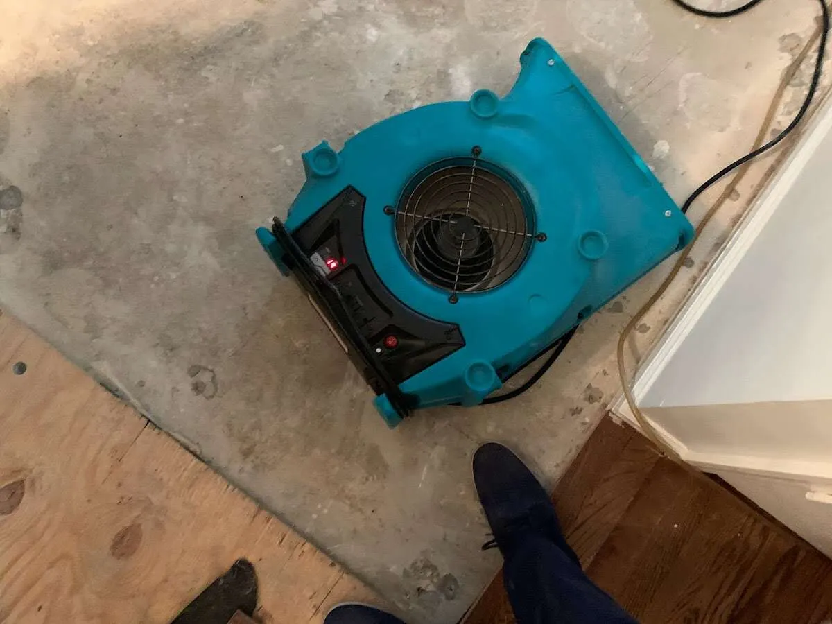 Air mover drying subfloor during Leak Detection & Repair in Medina